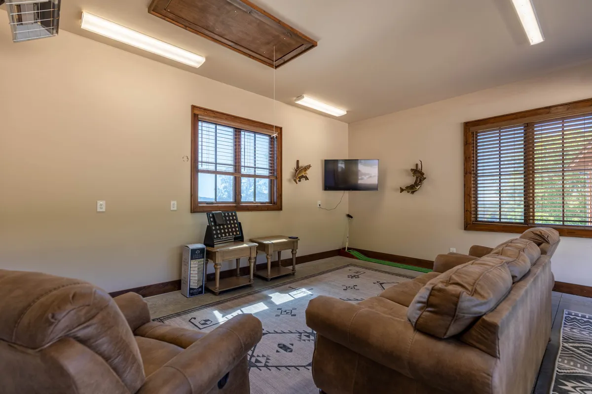 This interior image highlights a comfortable seating area with a television, ideal for family movie nights, playing games, or unwinding after a day of adventure. The relaxed, communal atmosphere supports the idea of indoor entertainment for all ages.